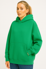 Person wearing a green hoodie on a plain background
